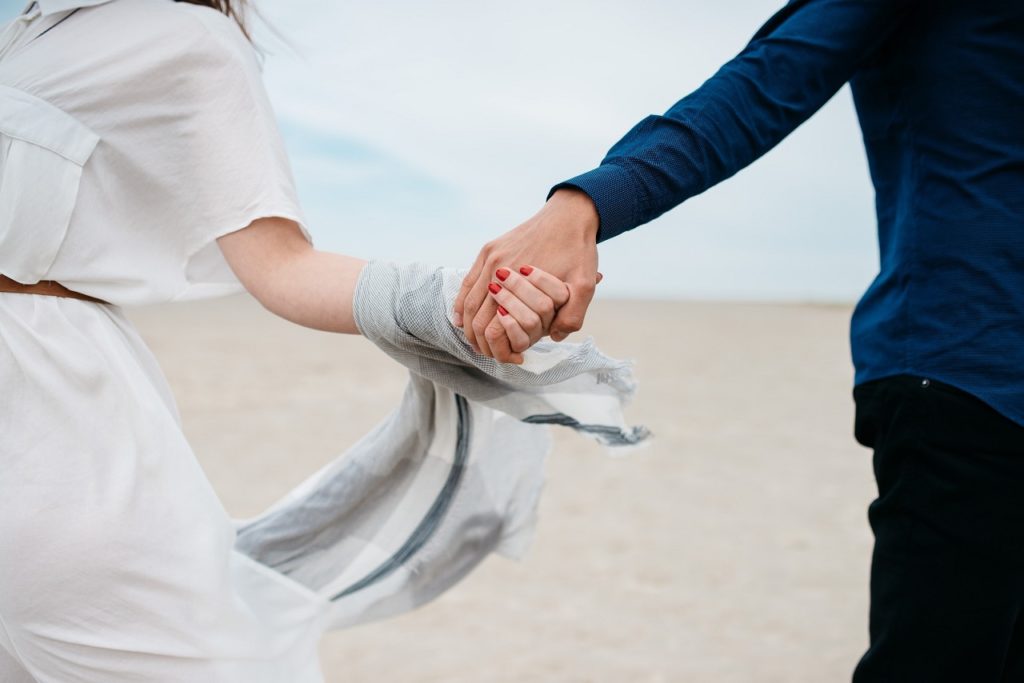 couple holding hands image