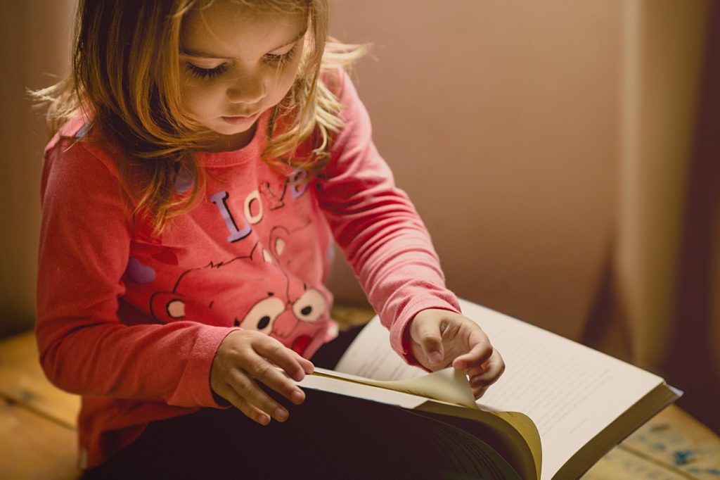 little girl reading book image