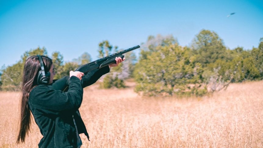 Woman holding a black rifle