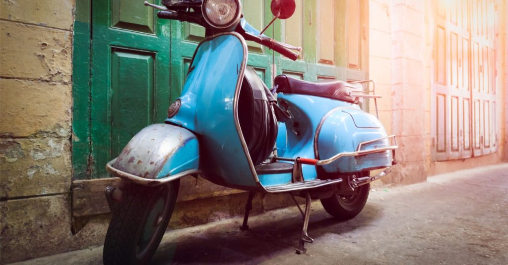 Vintage scooter stands in an alley