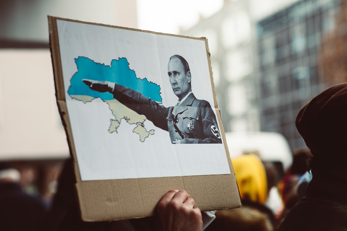 protestor holding placard of russian president vladimir putin