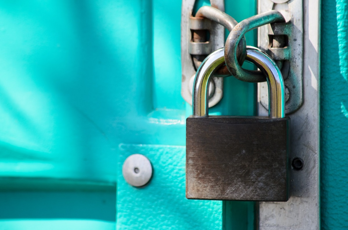 close up of lock securing blue gate