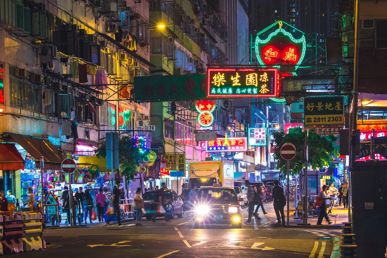 people on pedestrian lane in hong kong during night time
